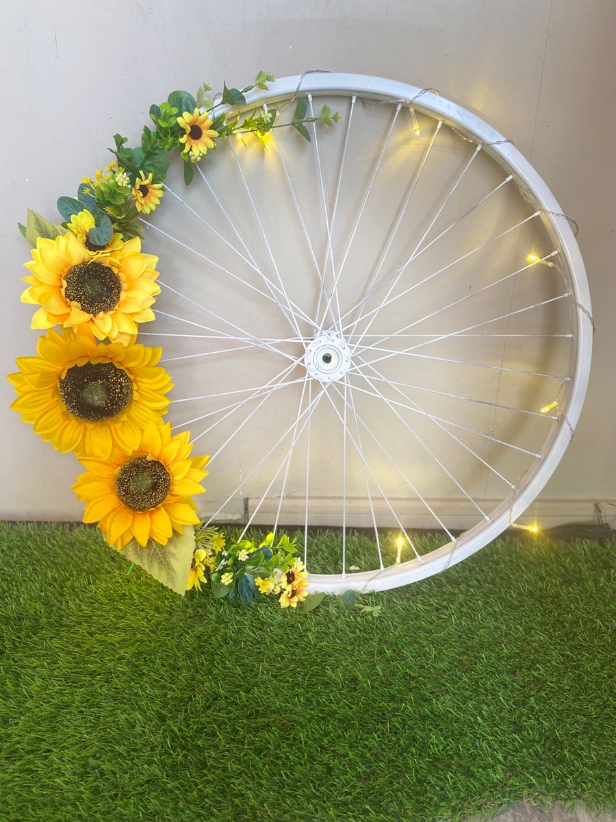 White bike wheel with yellow flowers